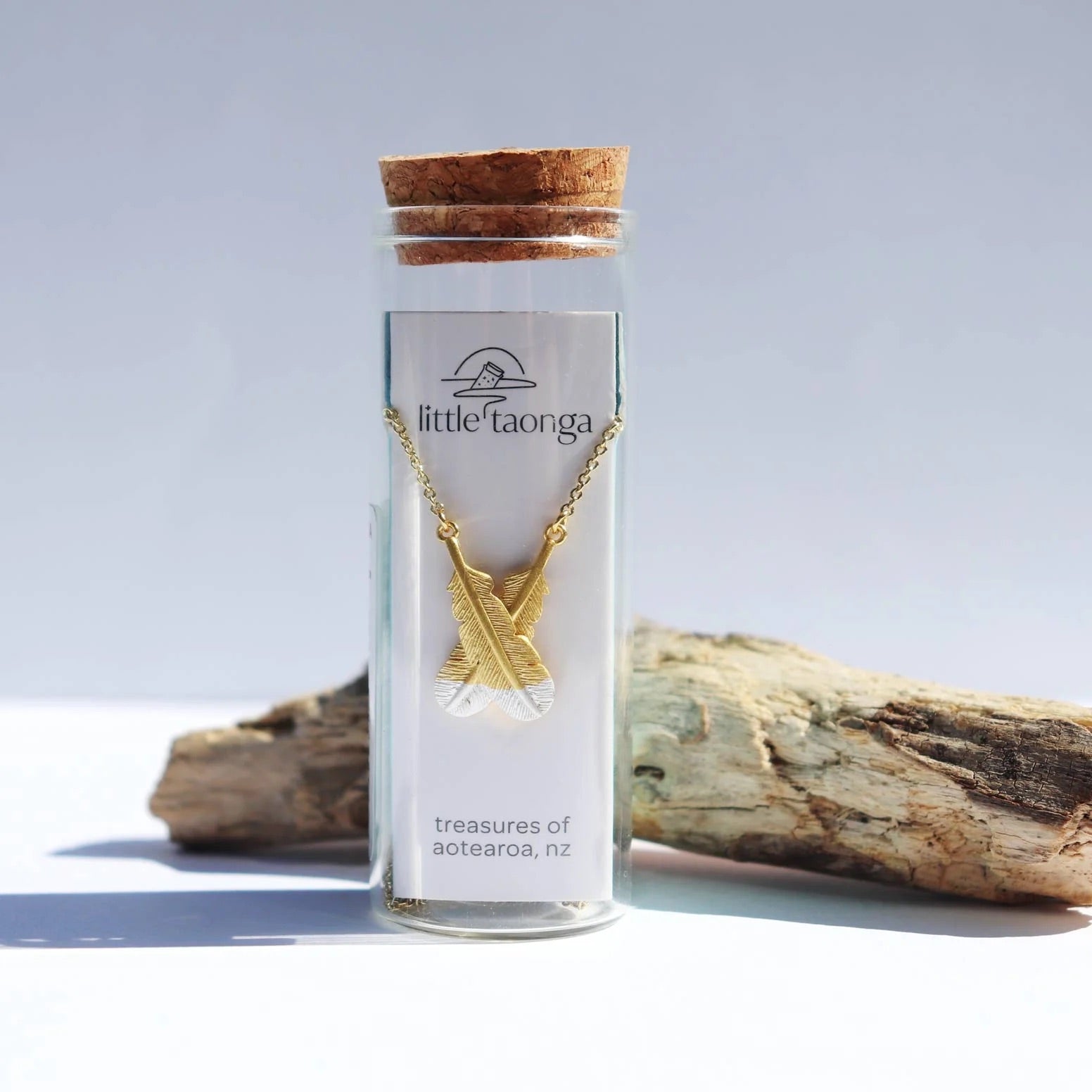 LITTLE TAONGA CROSSED FEATHER NECKLACE